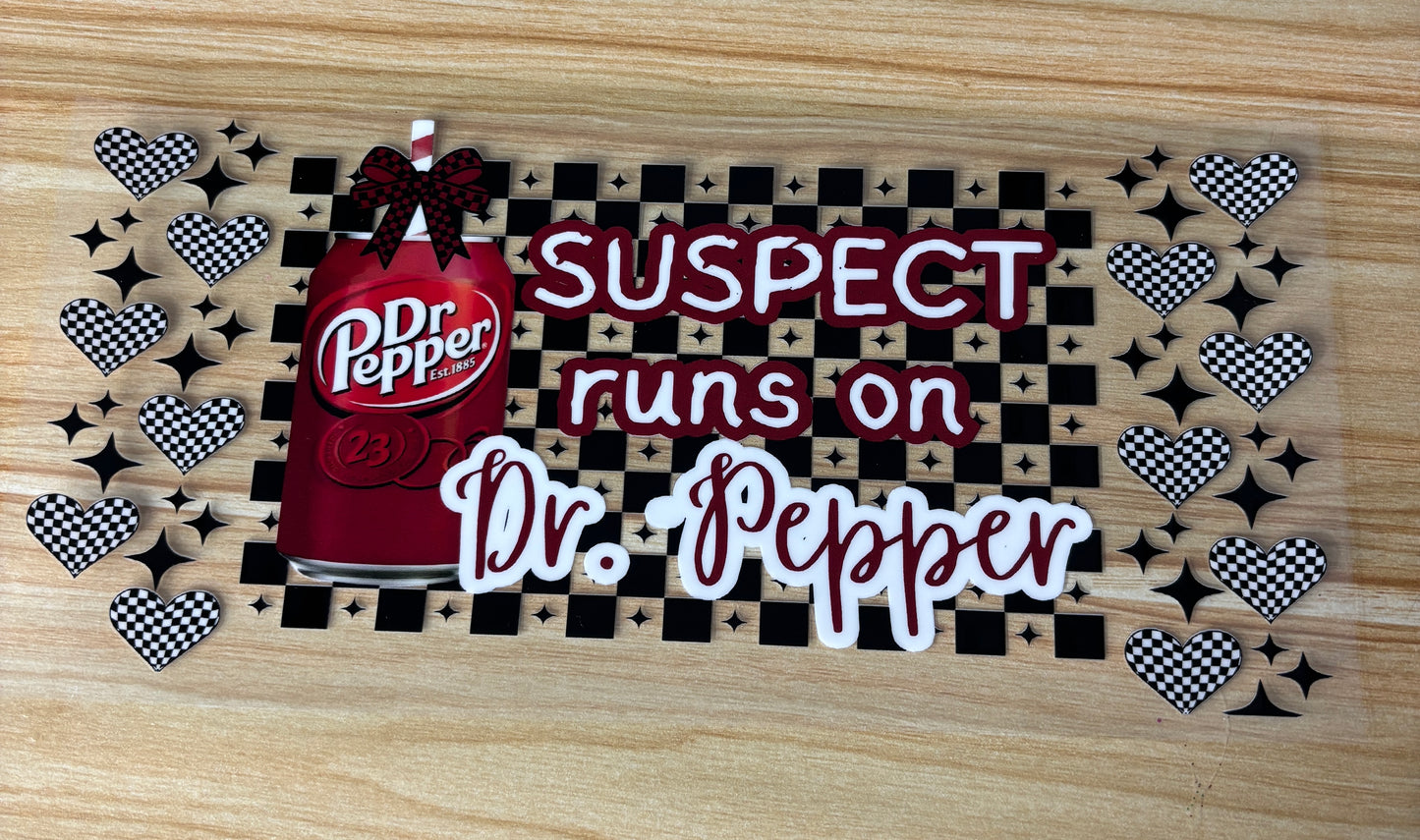 a red Dr. Pepper can with the text "Dr Pepper" written on it, surrounded by a pattern of hearts and stars.
