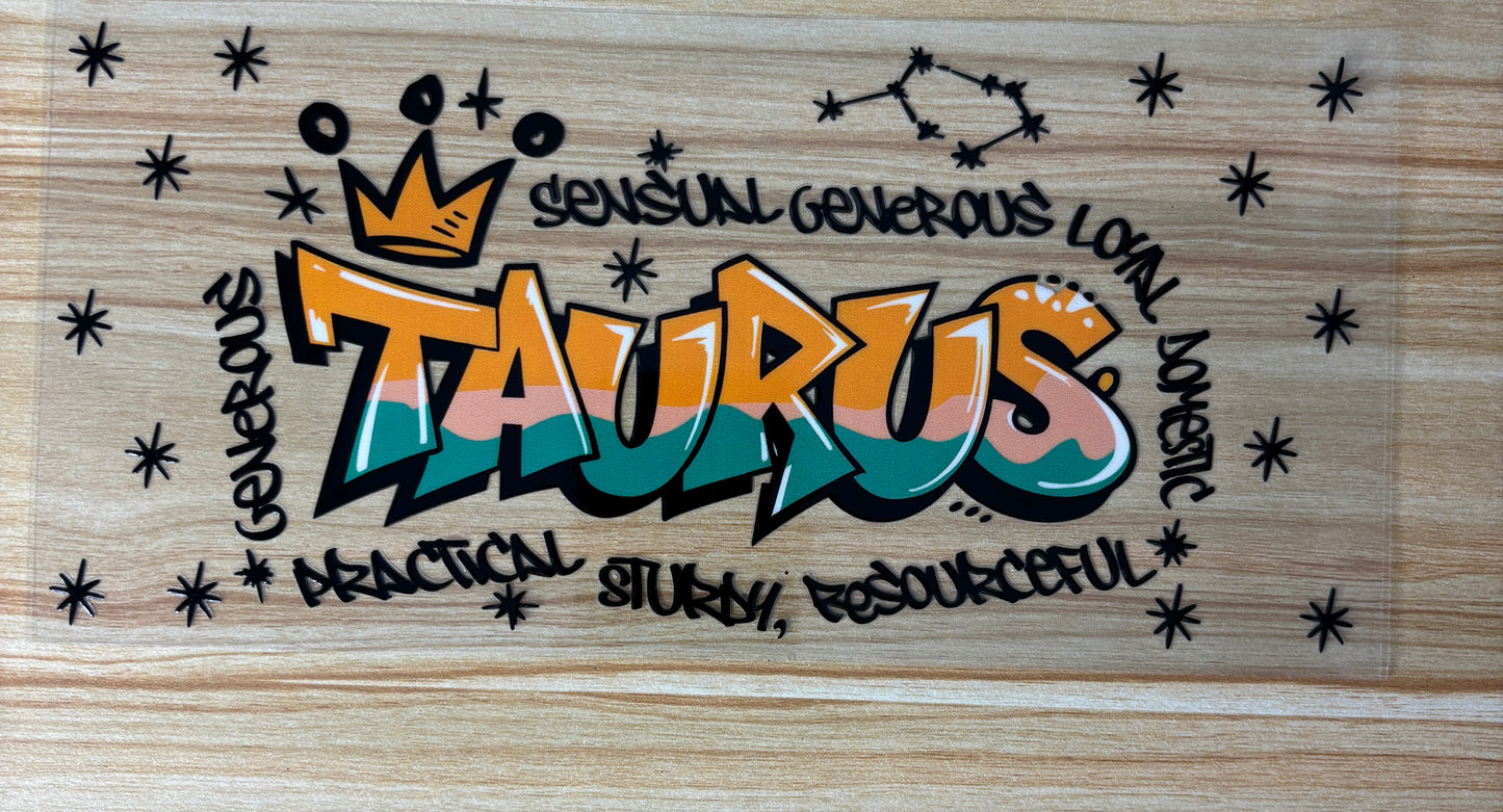 a colorful graffiti-style design with the word "Taurus" prominently displayed. Surrounding the word "Taurus" are various words and phrases such as "sensitive generous loving", "practical study", "resOURCEFUL", and "domicious". The overall design has a playful and artistic feel, with the use of stars and the word "Taurus" creating a visually striking composition.