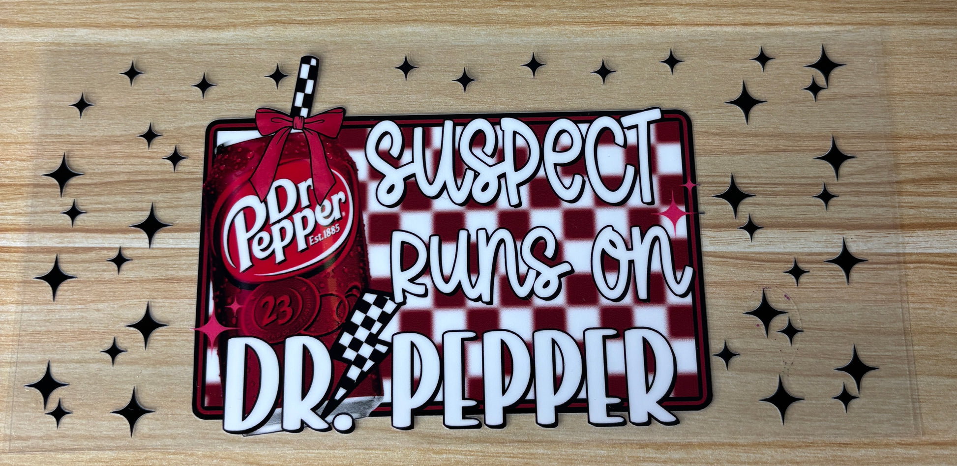a red and white checkered sign with the text "Suspect Dr. Pepper runs on Dr. Pepper" and a picture of a red and white striped bottle of Dr Pepper.