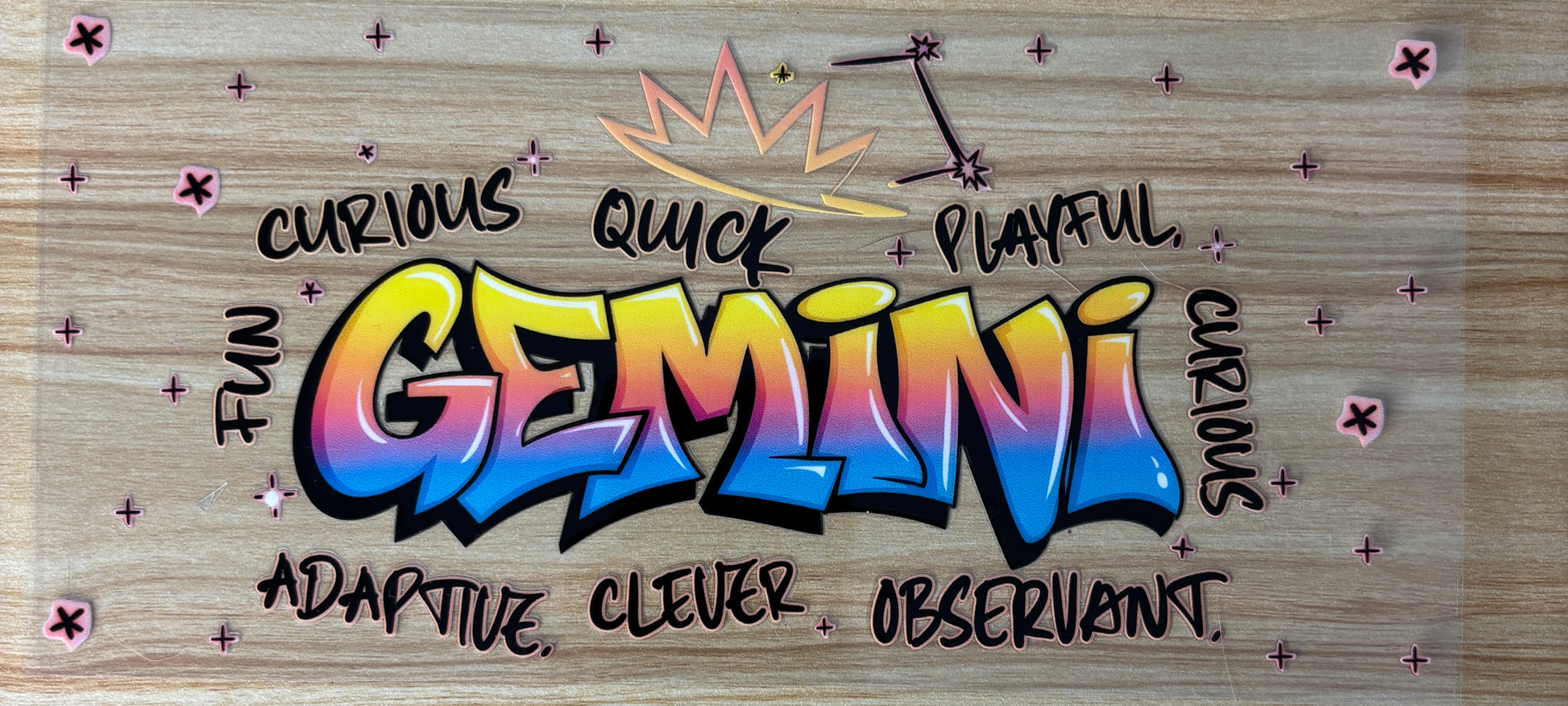 a colorful graffiti-style word "GEMINI" with various descriptions of the Gemini zodiac sign, such as "curious", "quick", "playful", "adaptive", "clever", and "observant", all written around the central text.
