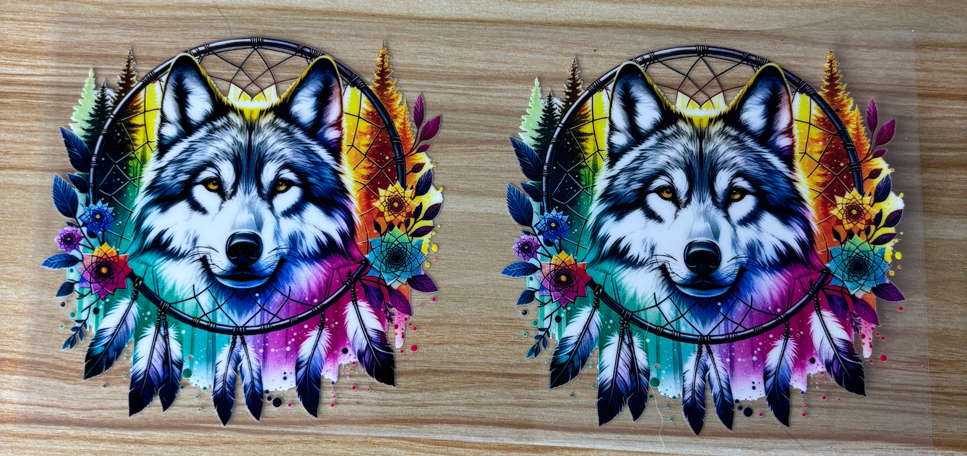 two colorful and vibrant dreamcatchers with the head of a wolf or wolf-like creature. The dreamcatchers are adorned with feathers, flowers, and other natural elements, creating a visually striking and artistic composition.