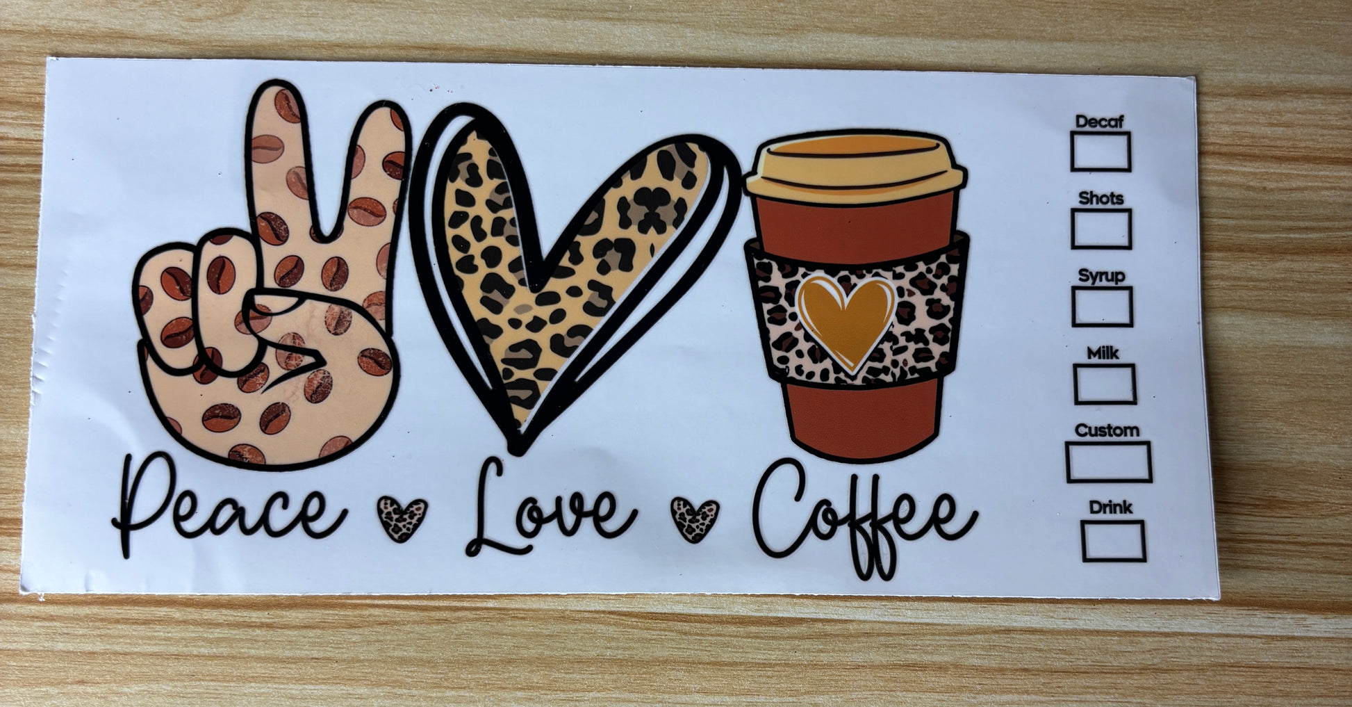 A coffee cup with a leopard print sleeve and a peace sign, along with the text "Peace Love Coffee" and a list of drink options.