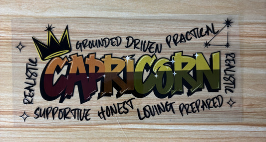 a colorful graffiti-style text that reads "CAPRICORN" with various words surrounding it, such as "grounded", "driven", "practical", "realistic", "supportive", "honesty", "loving", and "prepared".