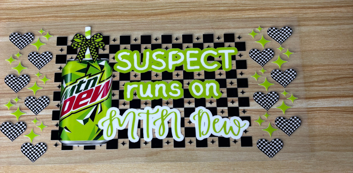 a can of Mountain Dew with a checkered pattern and a text overlay that reads "SUSPECT runs on Mtn Dew".
