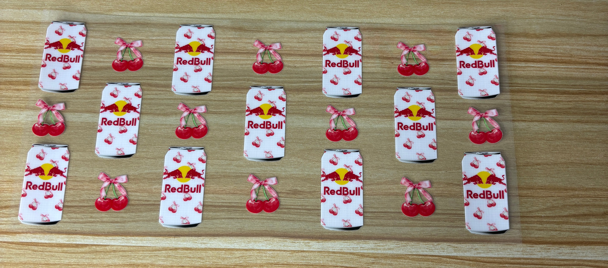 a collection of cans and cherries arranged on a wooden surface.
