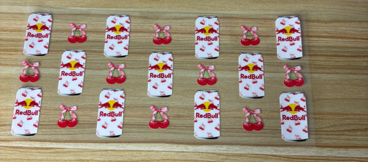 a collection of cans and cherries arranged on a wooden surface.